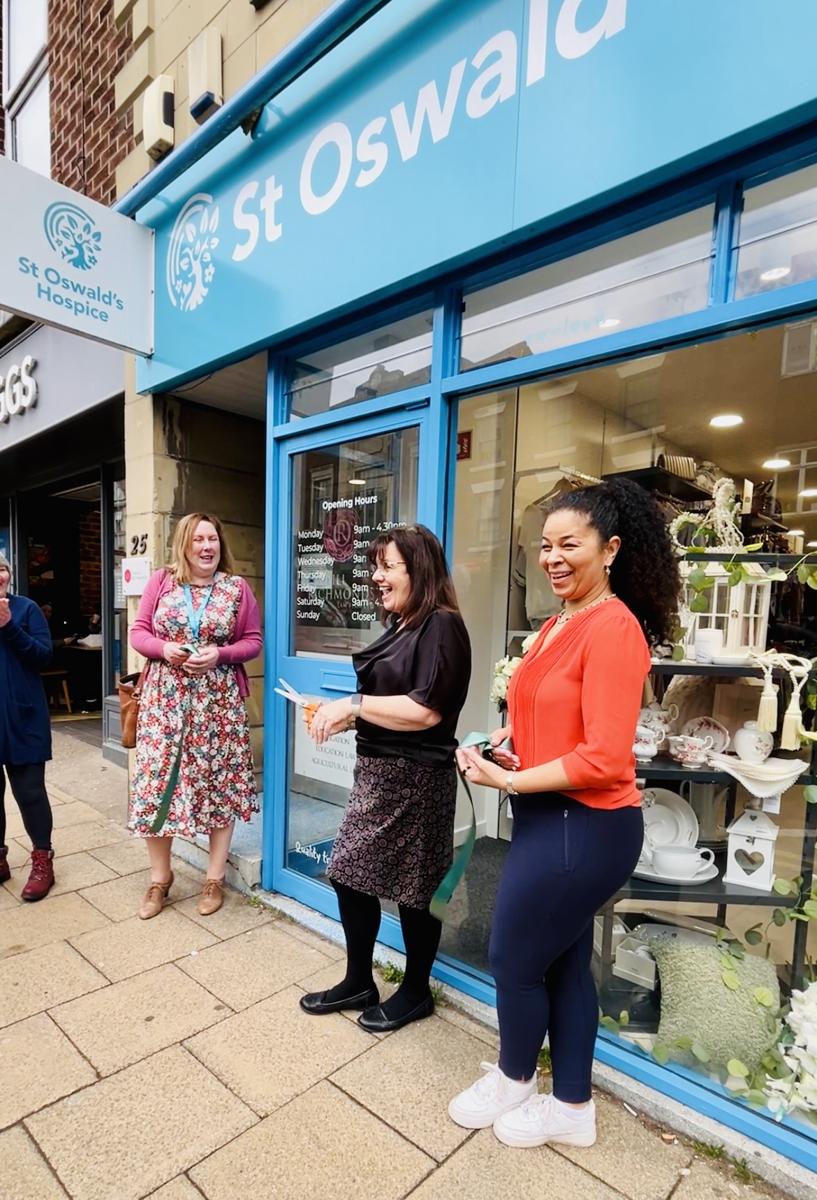 St Oswald's Hospice Morpeth Shop Re-opens March 19 2024 - Steph Edusei, Heather Gray and Anita Ball cut ribbon (2)